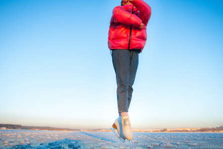 Woman legs in winter sportswear running on frozen field. Winter sport activity.の写真素材