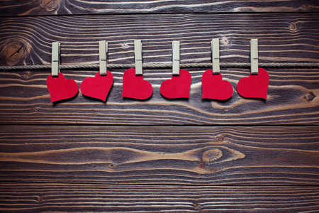 hearts on the clothespin on the wooden backgroundの写真素材