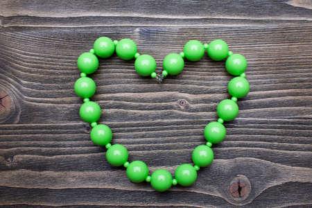 green beads on a wooden backgroundの写真素材