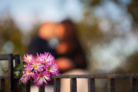 a bouquet of flowers on a background of a couple in loveの写真素材