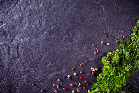parsley and dill with spices on a stone backgroundの写真素材