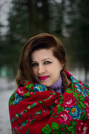 Portrait of lady in red scarf in winter park