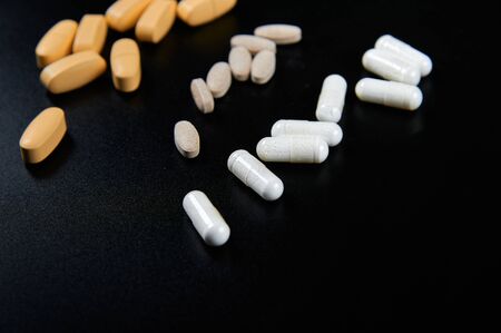 pills in pack on black background diagonalの写真素材