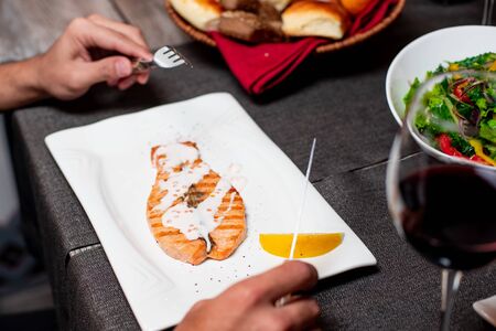 Fish in the plate on the table food dinerの写真素材