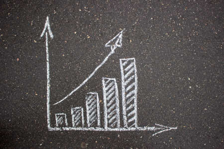 White simple business drawing on asphalt chalkの写真素材