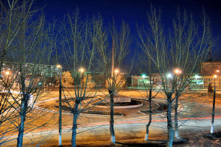 city at night with stars and cars and tracks from the