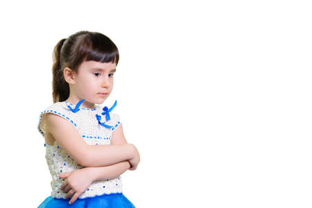 Funny smiling little girl portrait over white background. In a beautiful dress