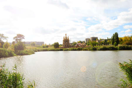 Church on the shore of the lake. Against the background of the city.の写真素材