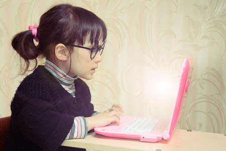 Baby in front of laptopの写真素材
