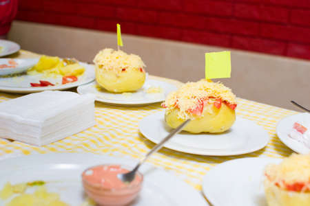 Stuffed potatoes on plates, close up viewの写真素材
