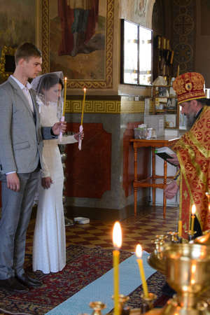 Alchevsk, Ukraine - April 28, 2017: Wedding ceremony of newlyweds in the Christian churchのeditorial素材