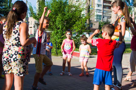Alchevsk, Ukraine - July 27, 2017: Happy children play with animators in summer -のeditorial素材