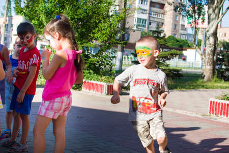 Alchevsk, Ukraine - July 27, 2017: Happy children play with animators in summer -のeditorial素材