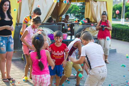 Alchevsk, Ukraine - July 27, 2017: Happy children play with animators in summer -のeditorial素材