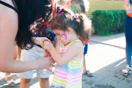 Alchevsk, Ukraine - July 27, 2017: Happy children play with animators in summer -のeditorial素材