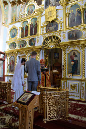 Alchevsk, Ukraine - April 28, 2017: Wedding ceremony of newlyweds in the Christian churchのeditorial素材