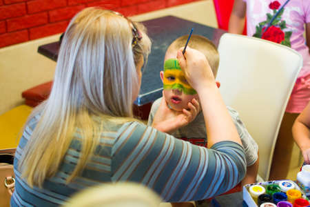 Alchevsk, Ukraine - July 27, 2017: Children's body painting with paintsのeditorial素材