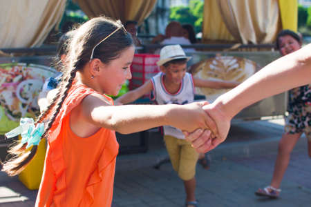 Alchevsk, Ukraine - July 27, 2017: Happy children play with animators in summer -のeditorial素材