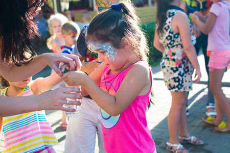 Alchevsk, Ukraine - July 27, 2017: Happy children play with animators in summerのeditorial素材