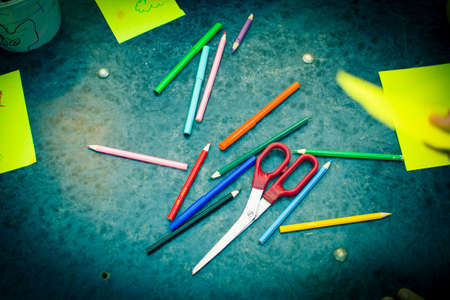 Pencils scissors paper on the table. Toned blue.の写真素材