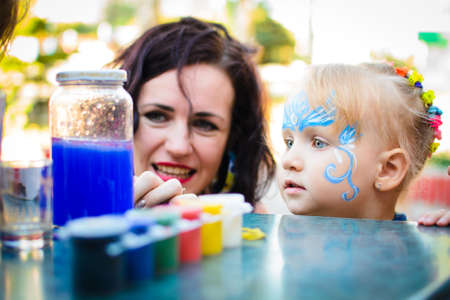 Alchevsk, Ukraine - August 17, 2017: Happy children play with animators in summer.のeditorial素材