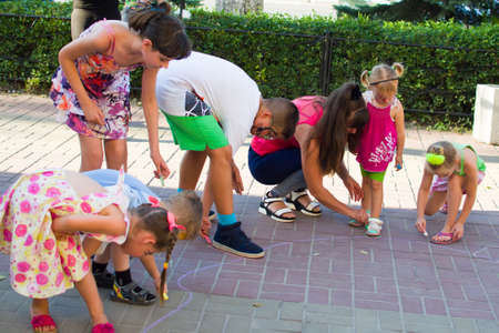 Alchevsk, Ukraine - August 3, 2017: Children draw chalk on the asphalt-のeditorial素材
