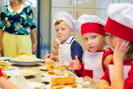 Alchevsk, Ukraine - September 17, 2017: School cook for children Preparing pizzaのeditorial素材