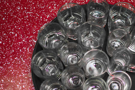 a lot of empty wine glasses on a tray.