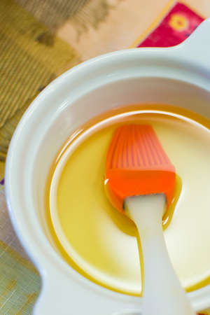 plate with olive oil and a brush