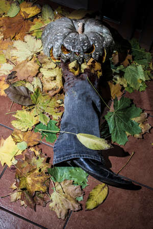 A pumpkin jack eats a man's leg. halloween.の写真素材