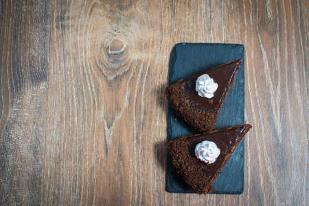 two pieces of cake on a stone plateの写真素材