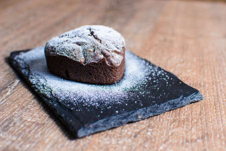 cupcake in the form of a heart with powdered sugar.