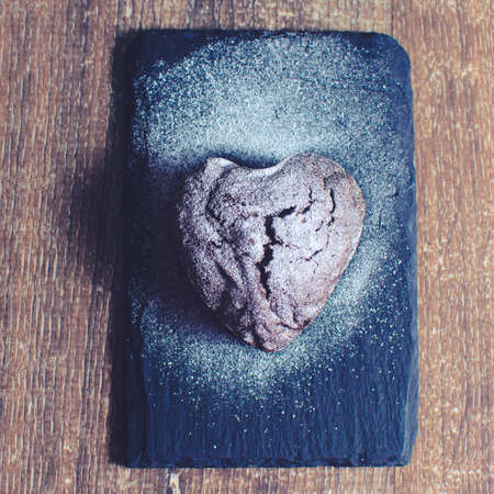 cupcake in the form of a heart with powdered sugarの写真素材