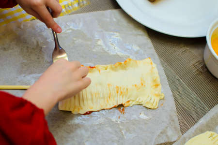 children prepare pies from bacon and cheese