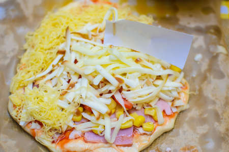 children cook pizza from raw ingredients with their own hands.の写真素材