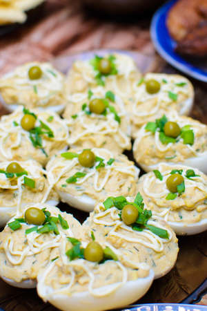 a lot of stuffed eggs on a festive table.