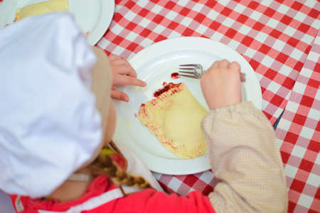 children cook a cheese patty with their own hands.の写真素材