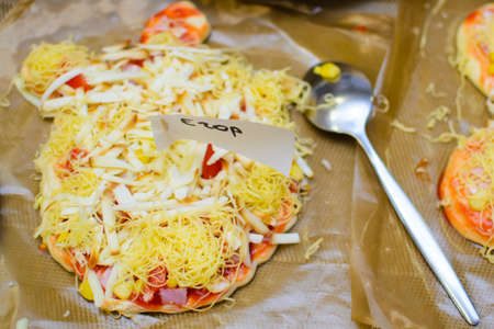 children cook pizza from raw ingredients with their own handsの写真素材