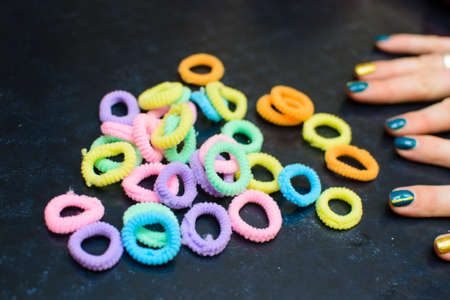 a lot of rubber bands for the hair and hands in the frameの写真素材