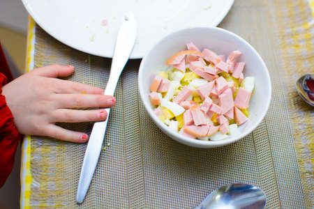 process of preparation of salad by the child at school of young cooks.の写真素材