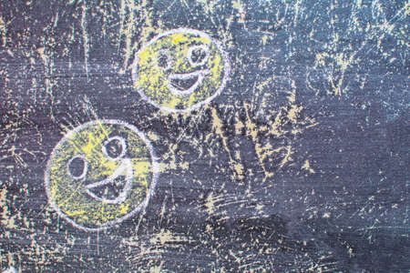 Smiley drawn chalk on an old school board