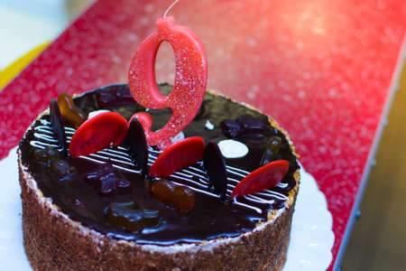 A close-up cake with the number 9 on the birthday, decorated with sweetsの写真素材
