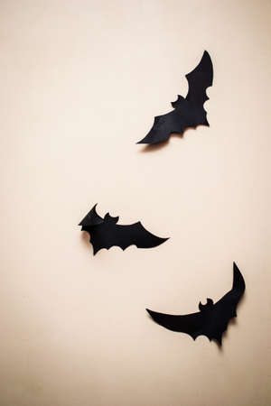 bats made of paper on a homogeneous dark background
