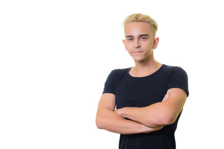 handsome trendy young guy in a black shirt on a white background. crossed his arms.の写真素材