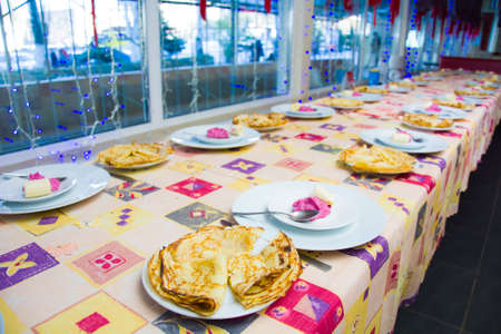 Alchevsk, Ukraine - November 21, 2018: children in the form of cooks prepare pancakes.のeditorial素材
