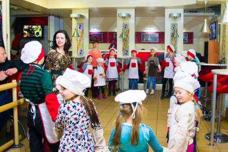 Alchevsk, Ukraine - November 8, 2018: children in the form of cooks prepare sandwiches.のeditorial素材