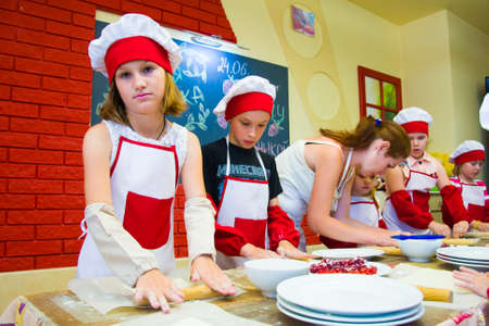 Alchevsk, Ukraine - November 8, 2018: children in the form of cooks prepare sandwiches.のeditorial素材