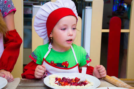 Alchevsk, Ukraine - November 8, 2018: children in the form of cooks prepare sandwiches.のeditorial素材