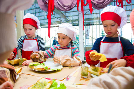 Alchevsk, Ukraine - November 8, 2018: children in the form of cooks prepare sandwiches.