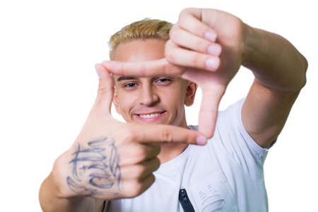 positive guy smiles broadly and poses for the camera.の写真素材